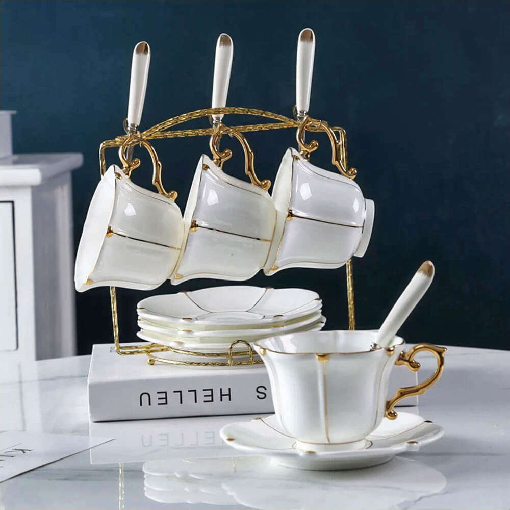 Luxurious bulk tea cups and saucers set in white and gold, elegantly arranged on a golden stand, perfect for gatherings or upscale tea service.