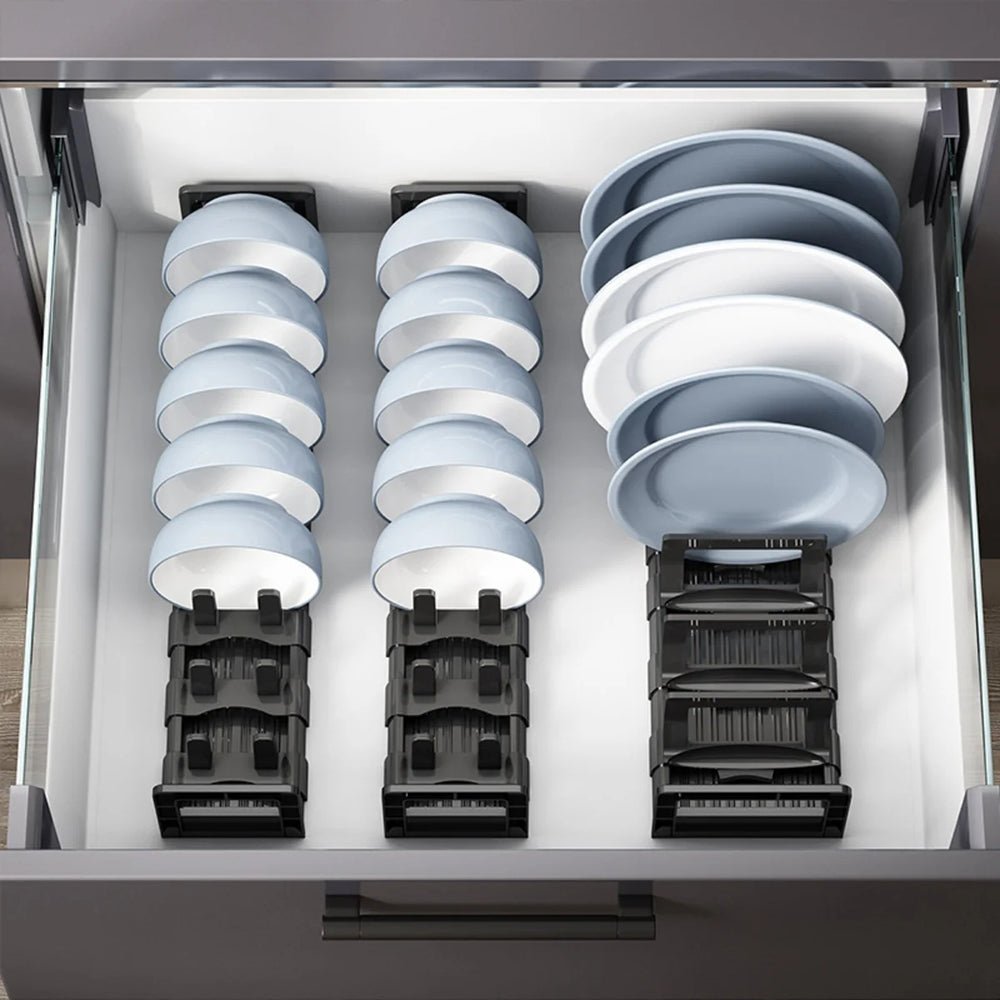 Three cabinet dish organizers inside a kitchen drawer, holding dinner plates, salad plates, and cereal bowls.