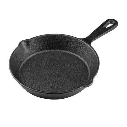 Black cast iron skillet on a white background