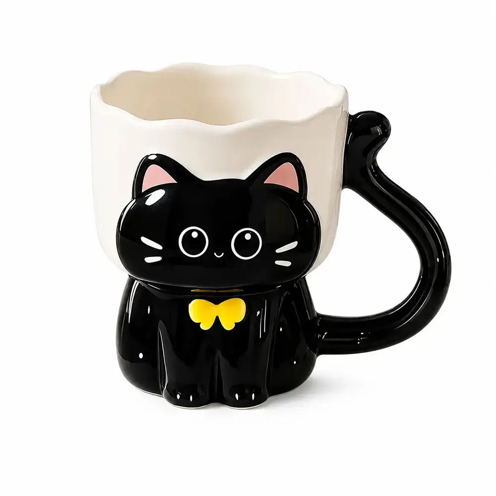 A ceramic mug shaped like a black cat sitting inside a white cup, with a curved black tail handle and a small yellow bow tie, shown on a plain white background.