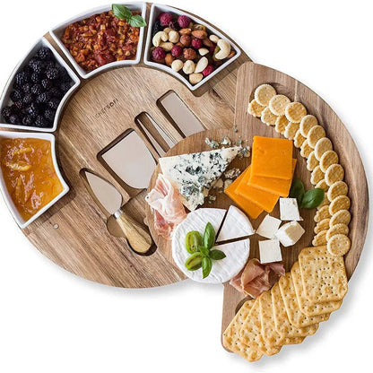 Wooden charcuterie board with assorted cheeses, crackers, and accompaniments on a white background.