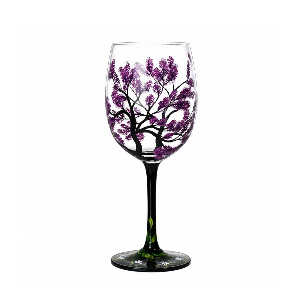 Cocktail goblet glass with a hand-painted purple flowering tree design, black stem, and decorative floral base.