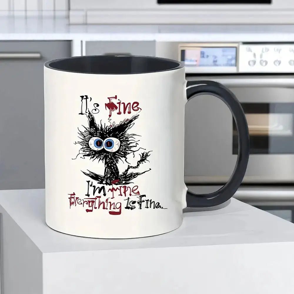 Coffee funny mug with black handle, showing a messy-haired cartoon cat with big eyes and the text &quot;It’s Fine, Everything is Fine.&quot;