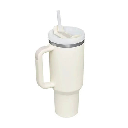 A cream-colored coffee tumbler stainless steel with a sturdy handle, secure lid, and straw, designed to keep drinks hot or cold for extended periods.