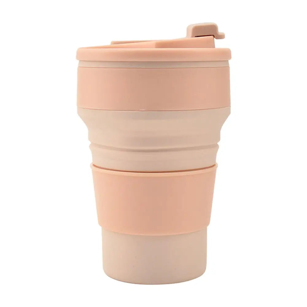 Collapsable tumbler in a folded design with lid and grip band, shown in a soft pink color on a white background.