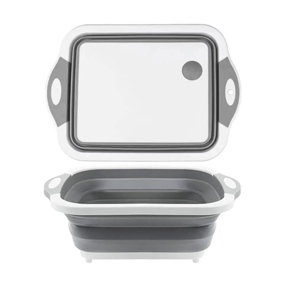 Gray and white collapsible cutting board shown expanded, featuring a cutting surface and deep basin for rinsing or food prep.