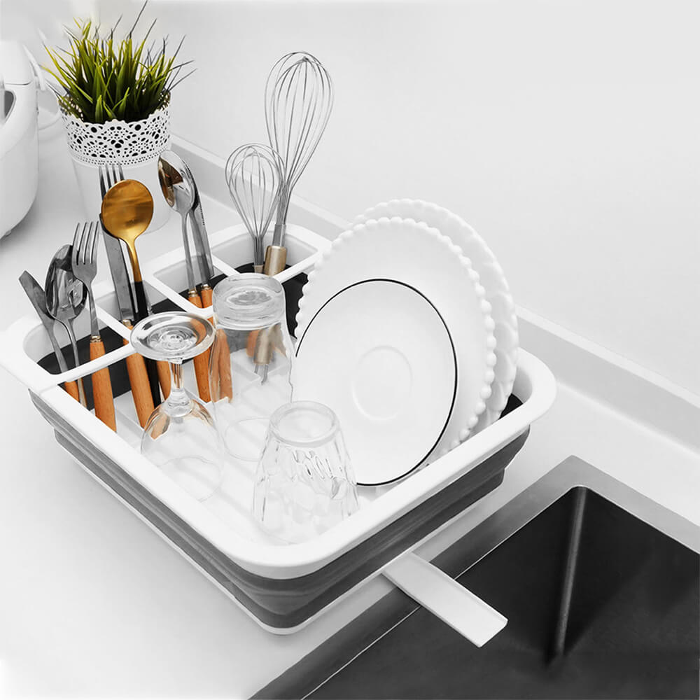 Collapsible dish rack camping essential with a white and gray design, featuring compartments for plates, utensils, and glasses, perfect for compact spaces.