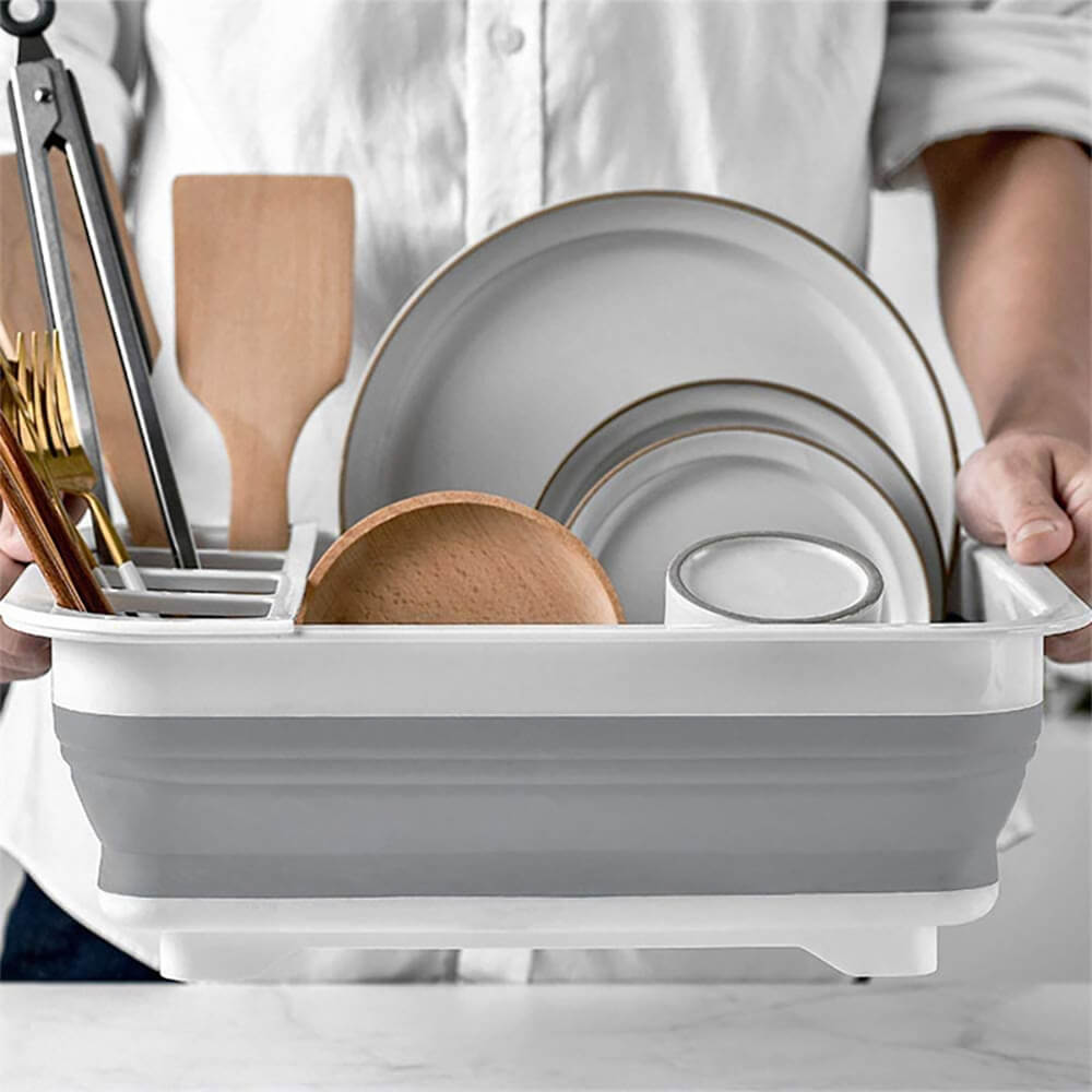 Collapsible dish rack for RV use, featuring a white and gray design with compartments for plates, utensils, and wooden tools, perfect for compact storage.