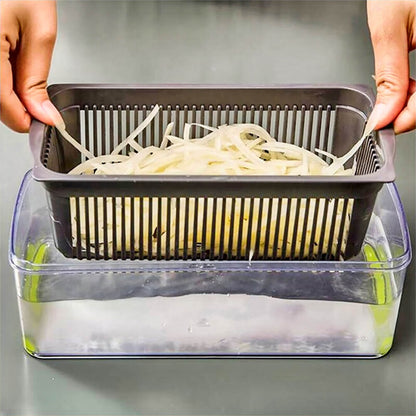 Hands holding strainer basket with sliced vegetables above clear container filled with water using commercial vegetable chopper.