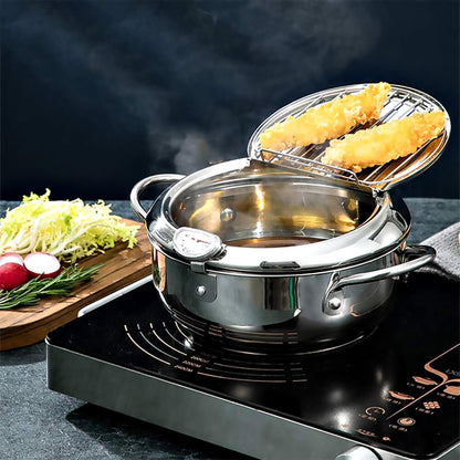 Stainless steel cookware for deep frying on electric stove with lid, fried food inside, and vegetables arranged on the side.