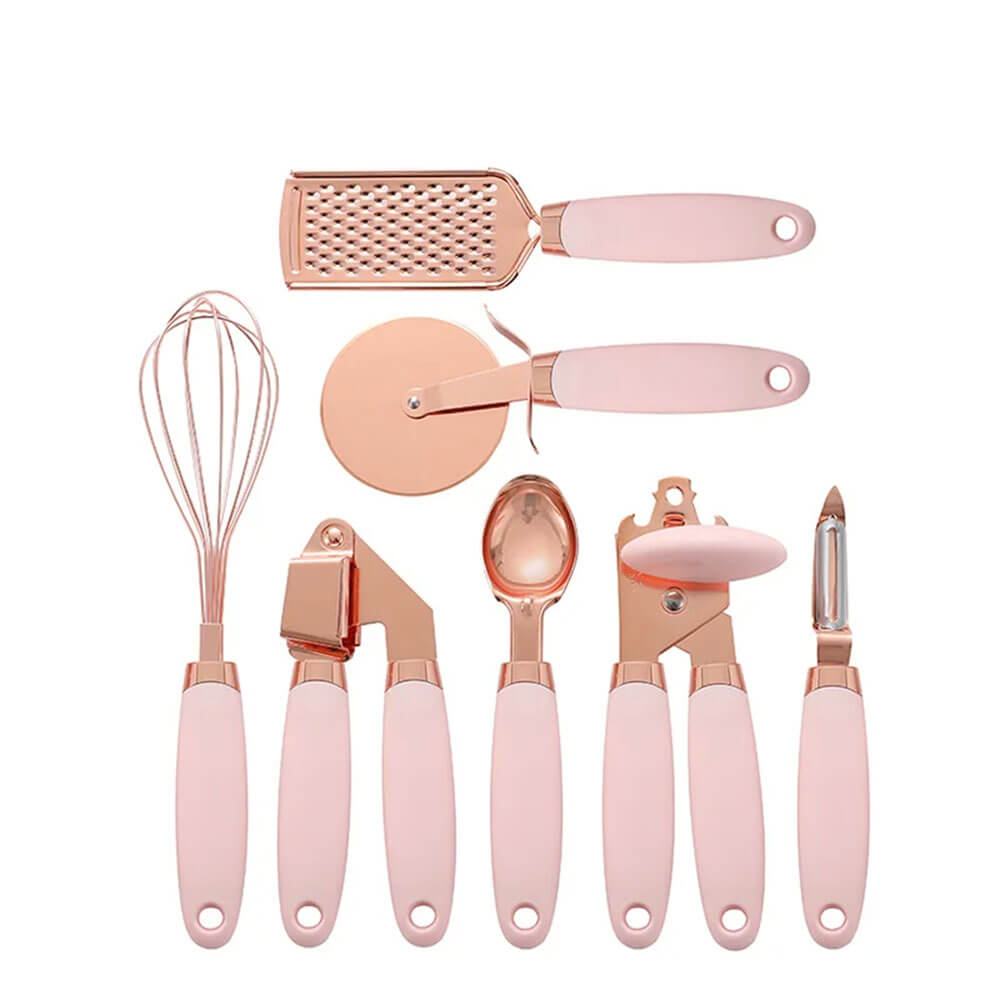 A chic copper kitchen tool set featuring rose gold utensils with soft pink ergonomic handles, including a whisk, grater, pizza cutter, garlic press, ice cream scoop, can opener, and peeler, perfect for elevating any modern kitchen.