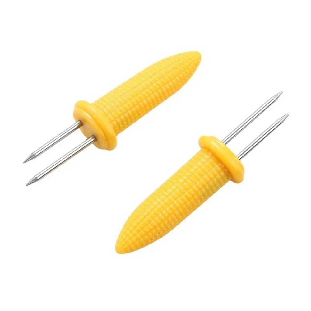 Set of yellow corn holders for corn on the cob with stainless steel prongs, designed for safe and easy handling during meals.