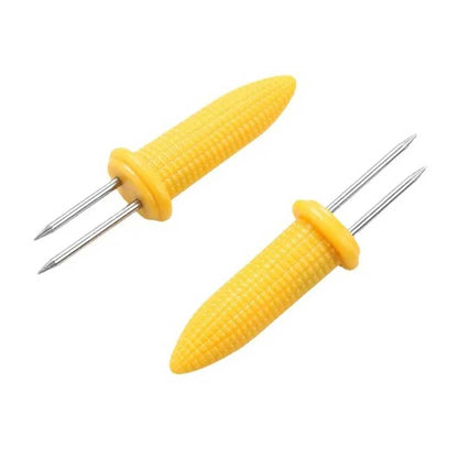 Set of yellow corn holders for corn on the cob with stainless steel prongs, designed for safe and easy handling during meals.