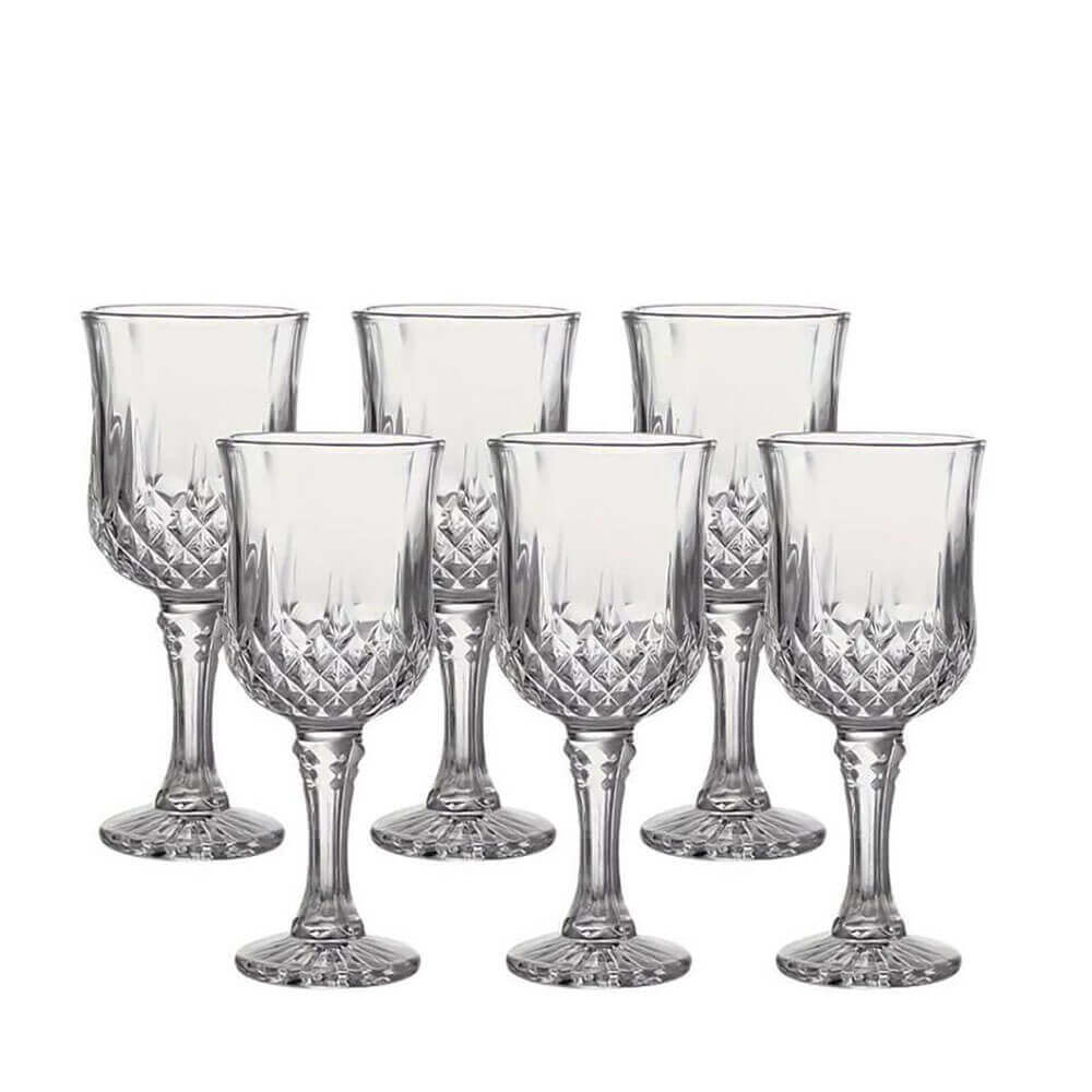Six intricately designed crystal glasses with diamond-cut pattern and flared bowls.