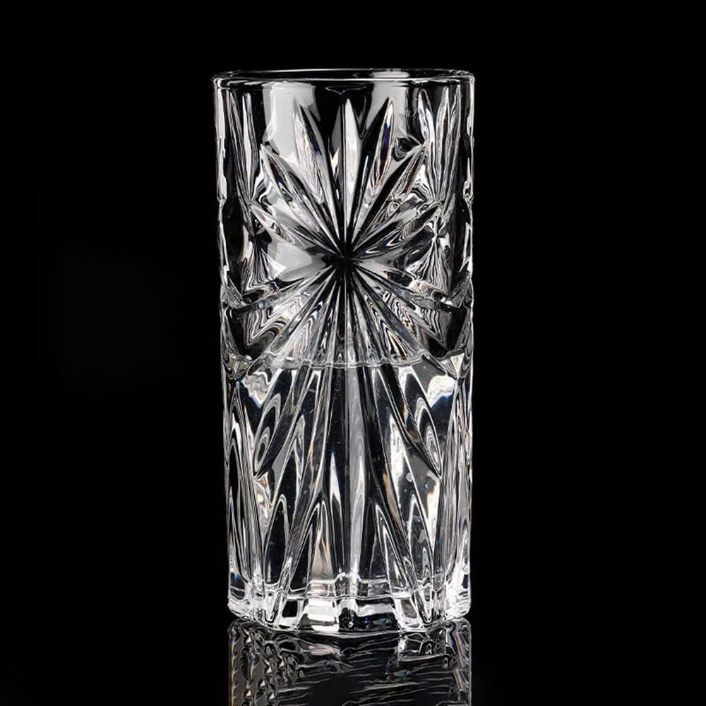 An elegant crystal highball glass with a stunning starburst pattern that sparkles under the light, showcasing its brilliant clarity and intricate design. Perfect for serving cocktails, sparkling water, or any beverage, these crystal highball glasses add a touch of sophistication to any table setting.