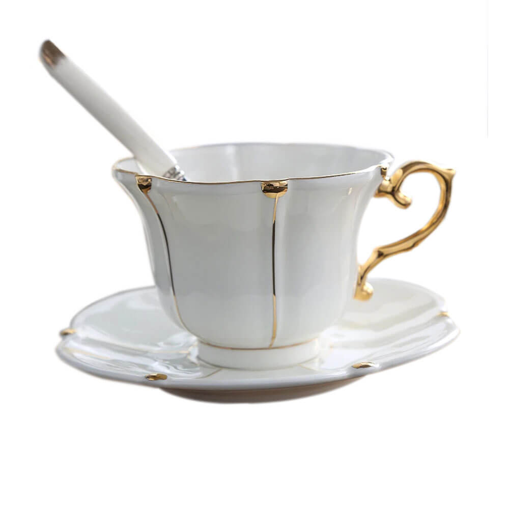 Elegant white and gold cups and saucers set with a matching spoon, featuring a timeless design that adds luxury and charm to any tea or coffee moment.