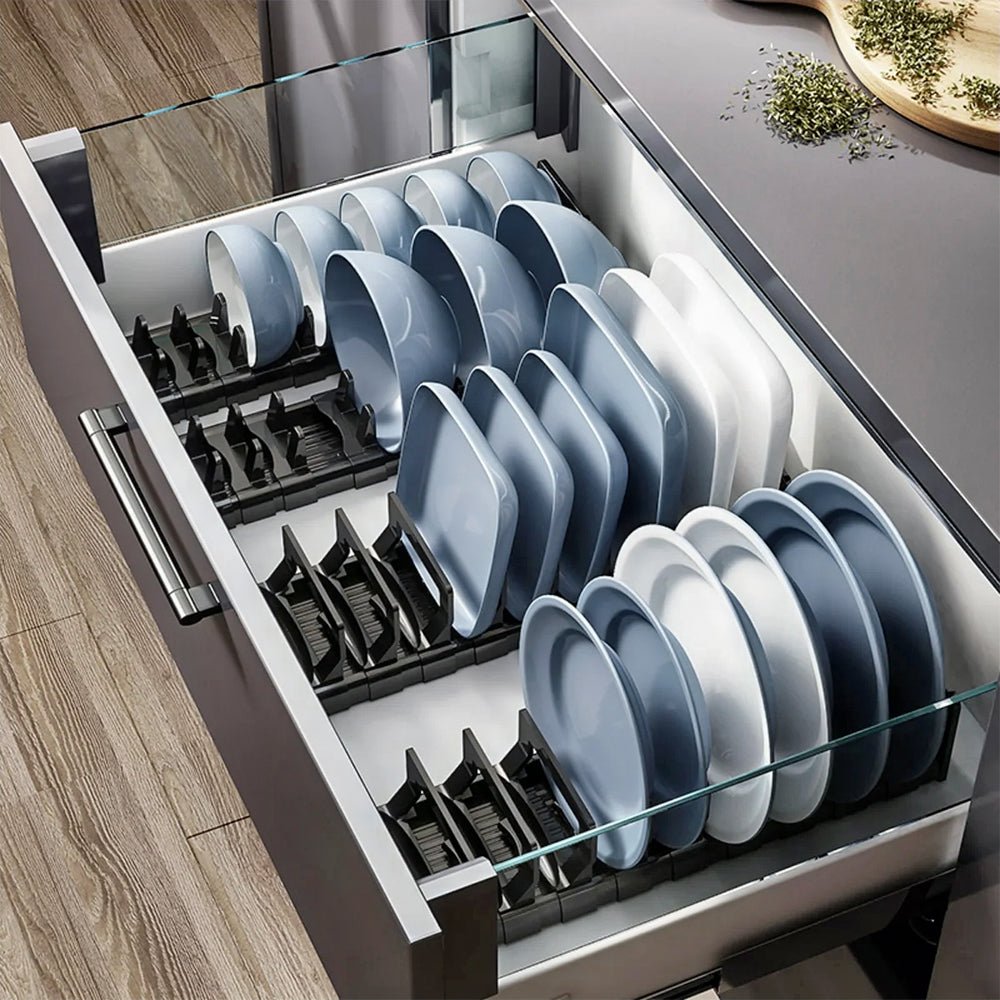 Four dish cabinets are organized in a drawer, neatly holding dinner plates, salad plates, and cereal bowls.