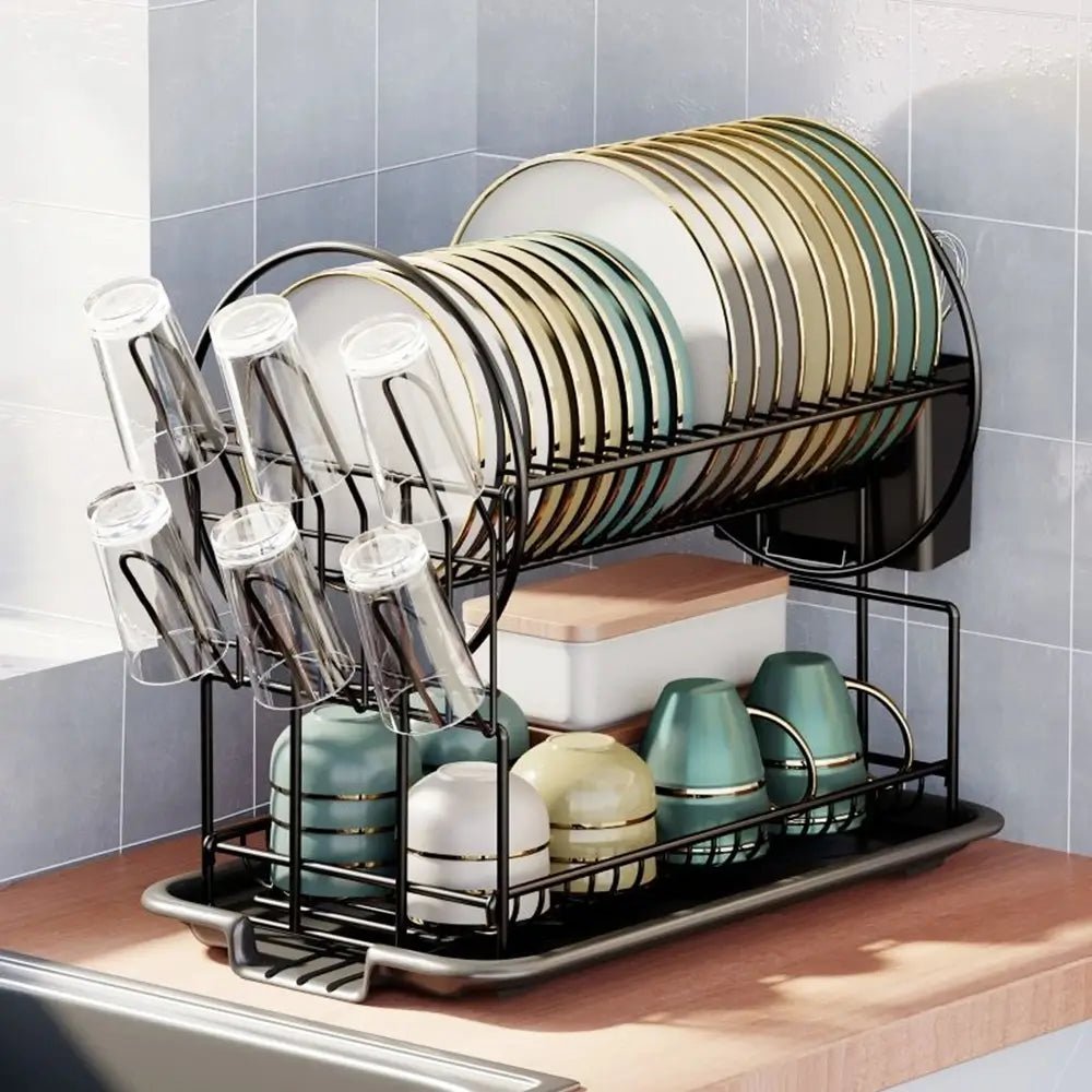 Dish drying rack with plates, glasses, and cups on a kitchen counter.