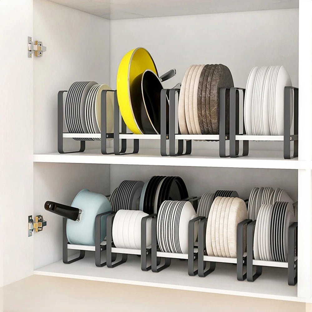 Dish storage racks in cabinet holding plates, yellow fry pan, bowls, and casserole, keeping kitchen essentials organized.