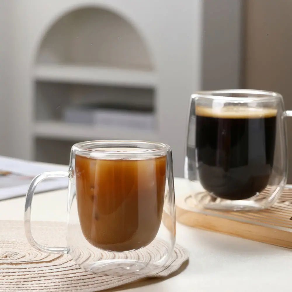 Two glass mugs with coffee on a table with a blurred background