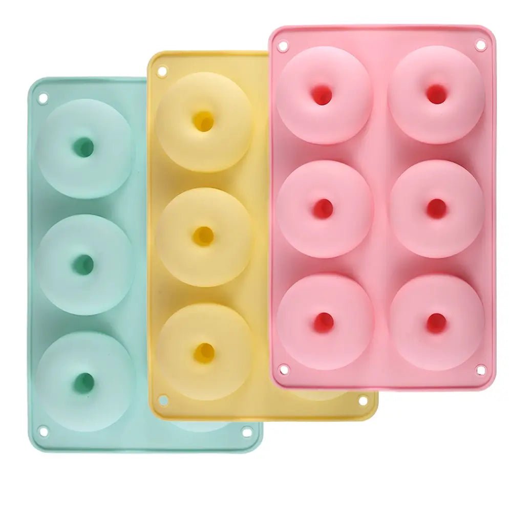 Three colorful silicone doughnut pans on a white background.