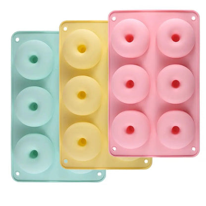 Three colorful silicone doughnut pans on a white background.