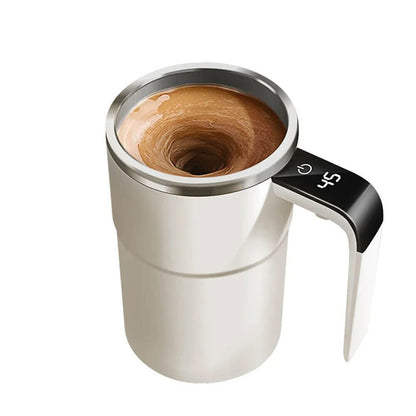 A sleek white self-stirring travel coffee mug with a stainless steel rim features an electric high-speed mixing mechanism, creating a visible vortex in the liquid. The ergonomic handle includes an LED display, showing the temperature for precision. This modern mug combines functionality and style, perfect for on-the-go use.