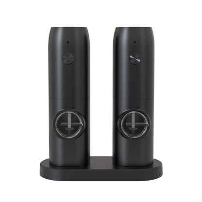 Black electric salt and pepper mills on matching stand, featuring clear spice windows and push button controls, isolated on white background.