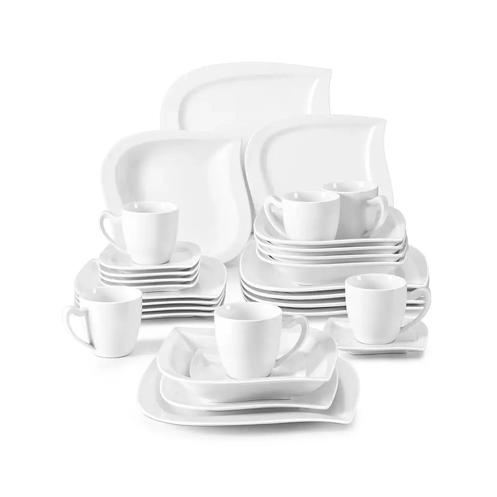 White porcelain everyday dinnerware set with plates, cups, and saucers, neatly arranged in a complete matching collection.