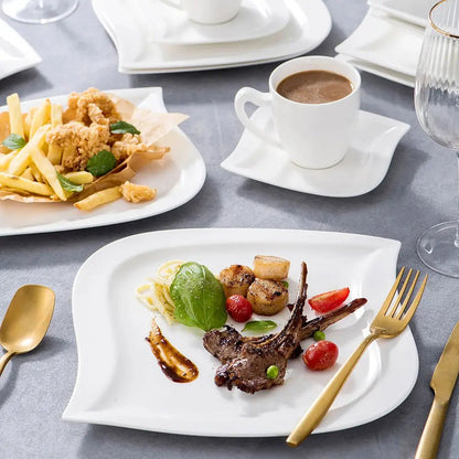 White everyday porcelain dinnerware sets with curved plates, cups, and saucers, served with lamb, fries, and coffee.