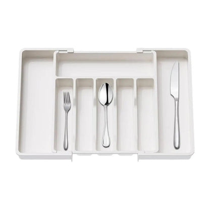 White expandable drawer organizers with adjustable sides and multiple compartments for versatile storage.