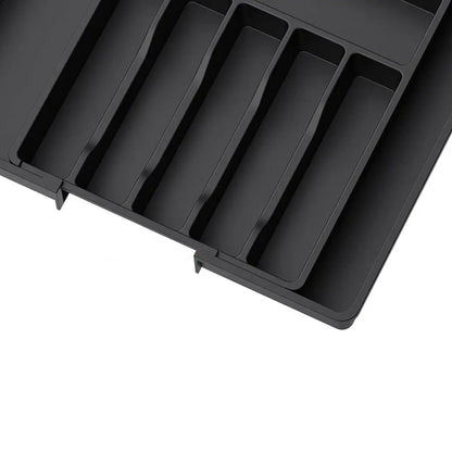 Expandable kitchen drawer organizer with adjustable sides, six compartments, ideal for utensils and gadgets.