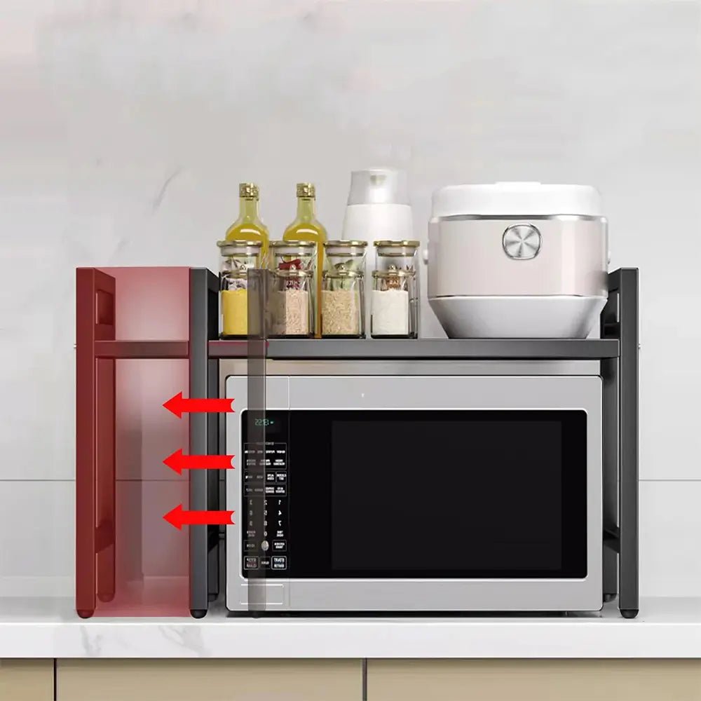 Expandable over microwave shelf with adjustable width, holding spice jars and rice cooker above a silver microwave.
