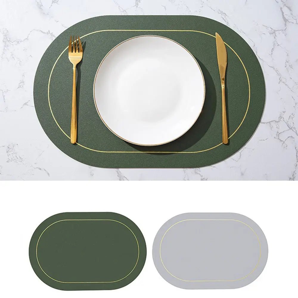Faux leather placemats Canada edition in dark green with gold trim, reversible to light gray, shown on a marble table with a white plate and gold cutlery.