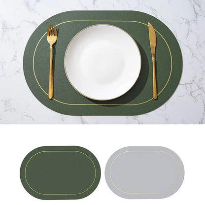 Faux leather placemats Canada edition in dark green with gold trim, reversible to light gray, shown on a marble table with a white plate and gold cutlery.
