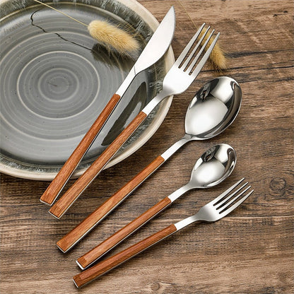 Elegant flatware with wood handles, set of 5. Includes fork, knife, spoon, dessert fork, and teaspoon. Made from durable 18/10 stainless steel.