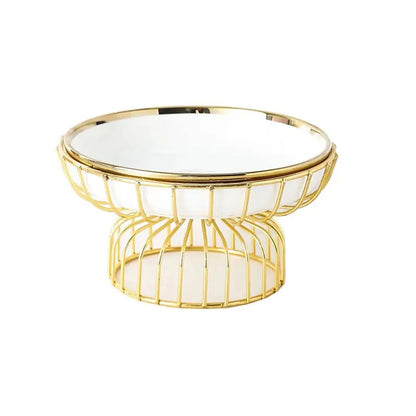 Minimal white ceramic pedestal fruit bowl with gold wire base, modern elevated serving bowl for kitchen or dining decor.
