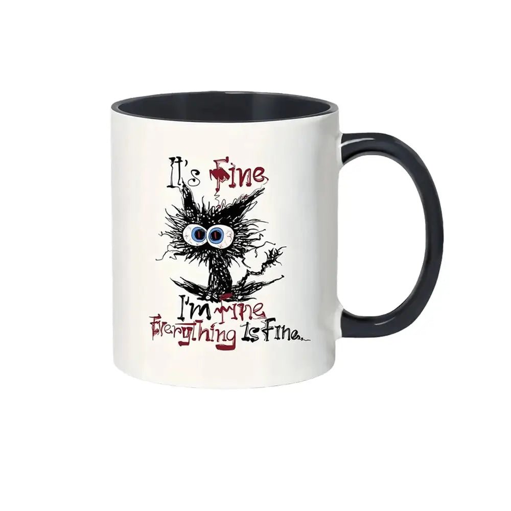 White ceramic funny mug with black handle featuring a cartoon cat with wild hair, big blue eyes, and text saying &quot;It&