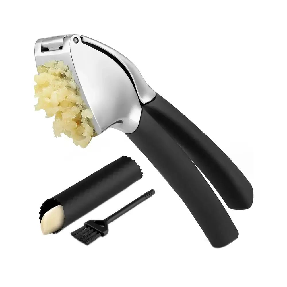 Stainless steel garlic press with black handles, shown with crushed garlic, a silicone garlic peeler tube, and a cleaning brush.