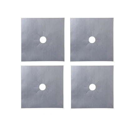 Set of four silver gas stove protectors with circular center cutouts for fitting around burners.