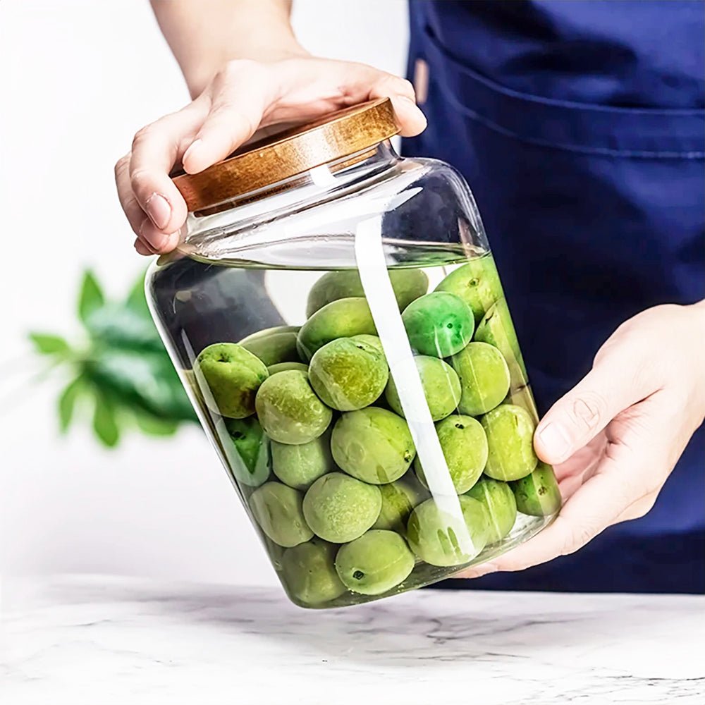 Large glass jar with lid, ideal for storing kitchen essentials like coffee, sugar, and grains.