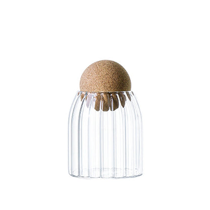 Glass jar with cork lid, ideal for stylish storage of ingredients like sugar, tea, coffee, and beans.