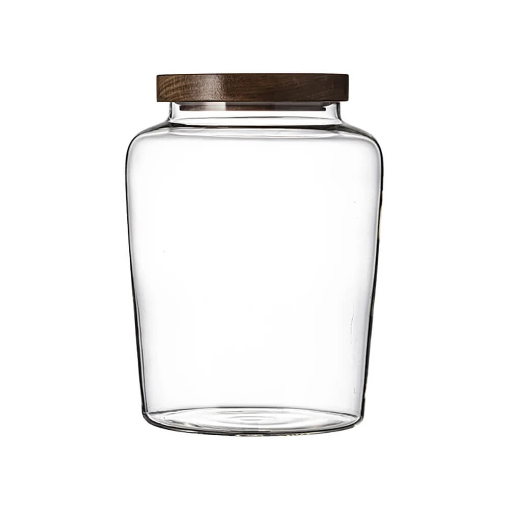 A transparent glass jar with a wooden lid is displayed against a plain white background. The jar has a simple, modern design with a smooth, rounded shape. The wooden lid fits securely on top, likely featuring an airtight seal for freshness.
