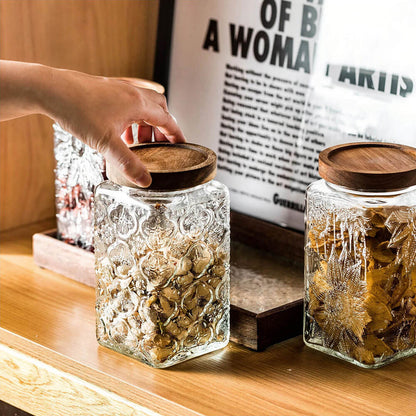 Stylish glass kitchen canister set featuring acacia wood lids for elegant storage solutions.