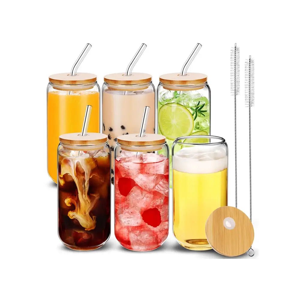 Set of glass tumbler with straw, bamboo lids, and metal straws, filled with iced drinks, juice, and fruit-infused beverages