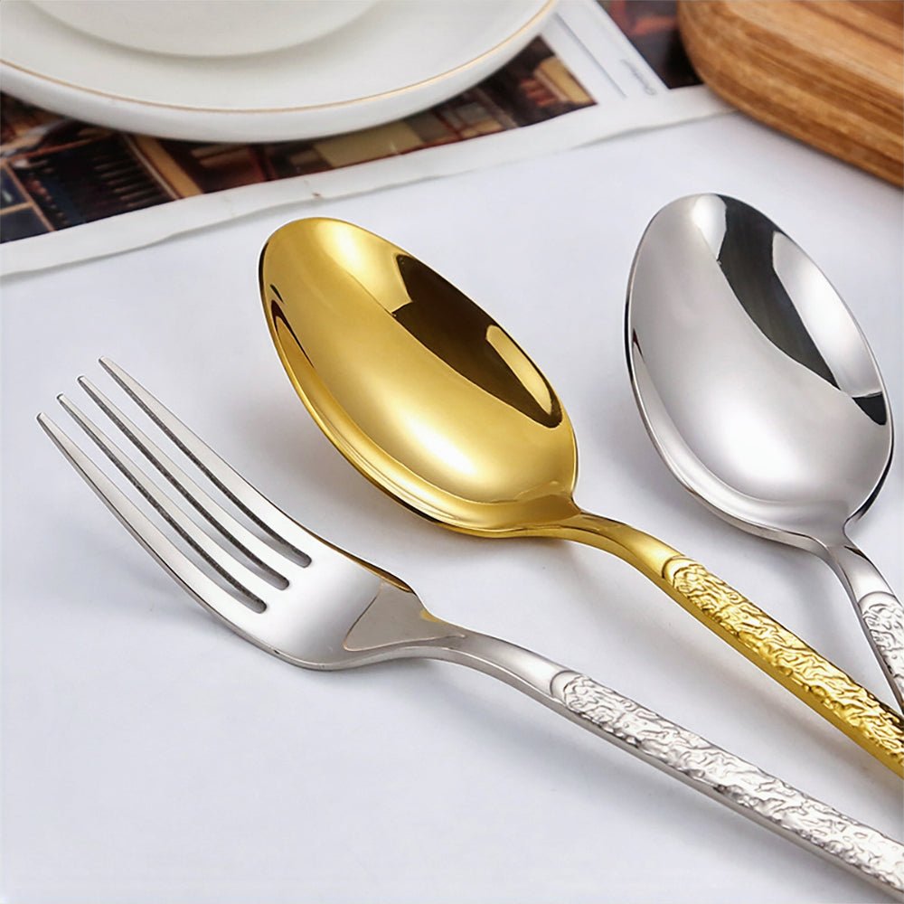 Gold cutlery set, featuring a dinner fork, salad fork, dinner knife, soup spoon, and teaspoon.