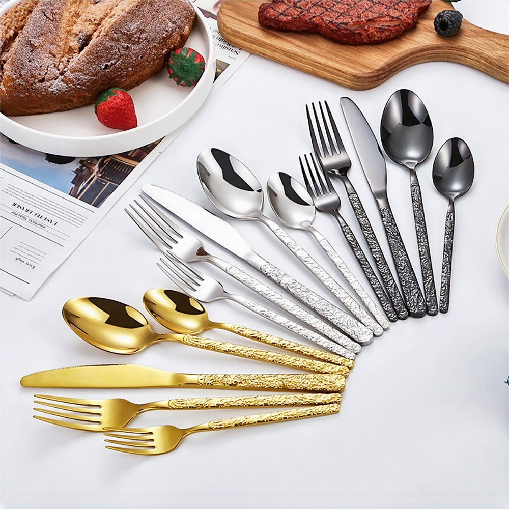 Gold silverware set, 5 pieces: dinner fork, salad fork, dinner knife, soup spoon, and teaspoon.