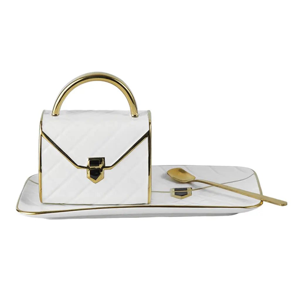 White handbag coffee mug with gold accents on a white background.