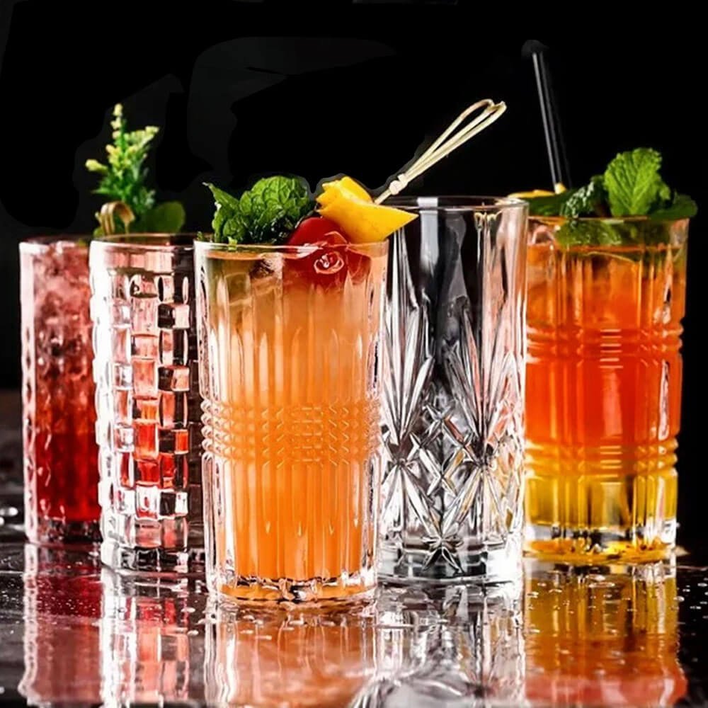 A vibrant highball glass set featuring an assortment of intricately designed crystal glasses, each filled with colorful cocktails garnished with fresh herbs and fruits. This elegant set showcases various patterns, perfect for elevating any beverage presentation and adding sophistication to your drinkware collection.