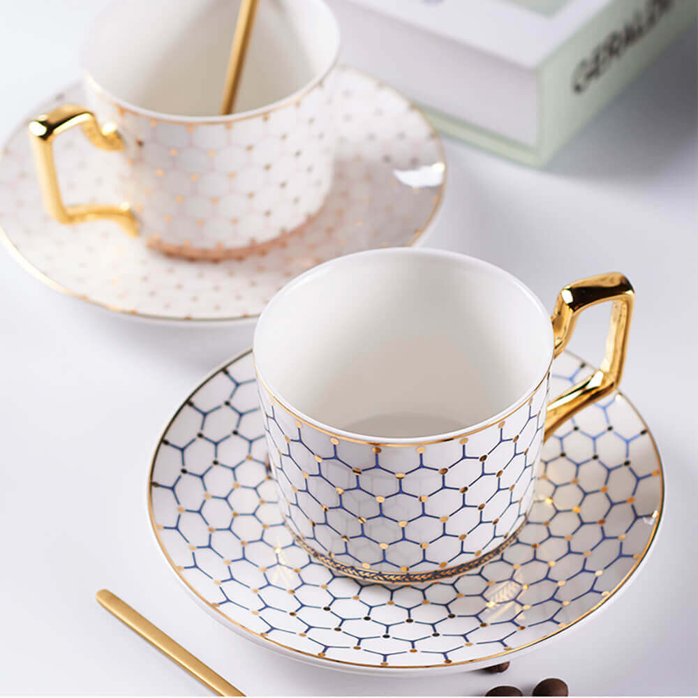 Elegant honeycomb tea set featuring intricately designed cups and saucers with a gold handle and delicate honeycomb pattern, perfect for a luxurious tea time.